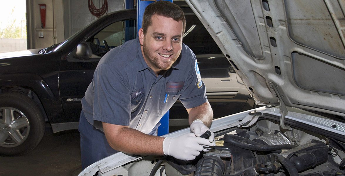 Smiling Ray Frey technician at an open hood